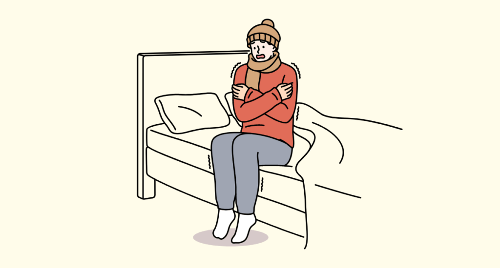 部屋で寒がる人のイラスト